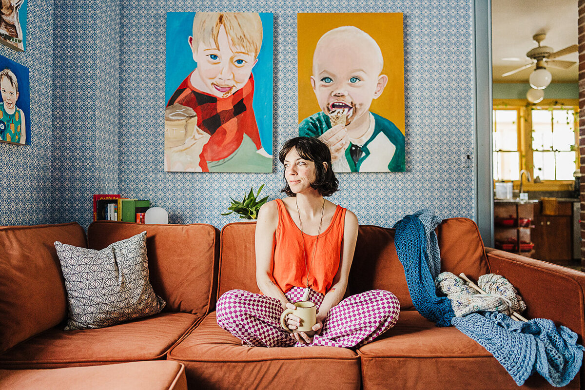 woman sits on colorful couch for designer headshots