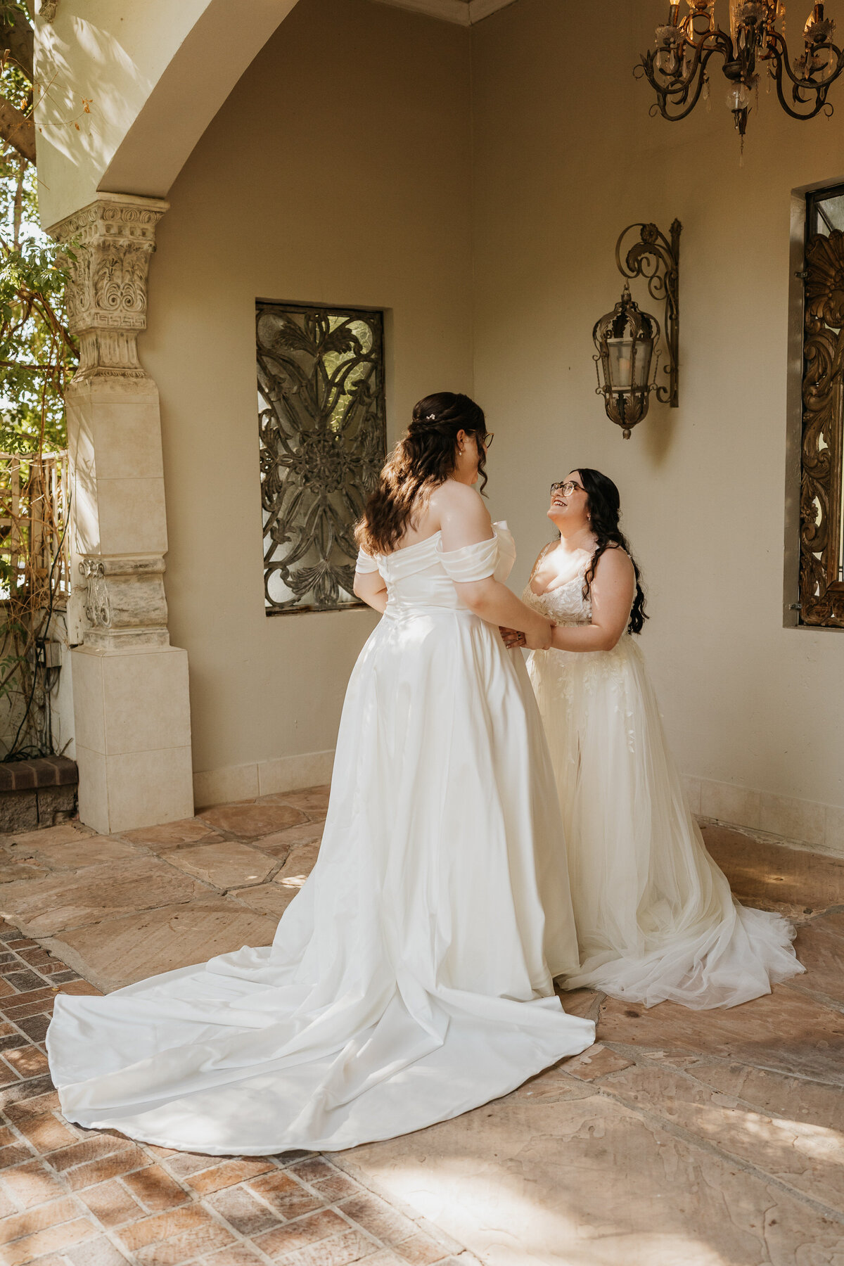 A newlywed wed couple with their arms around each other smiling together 
