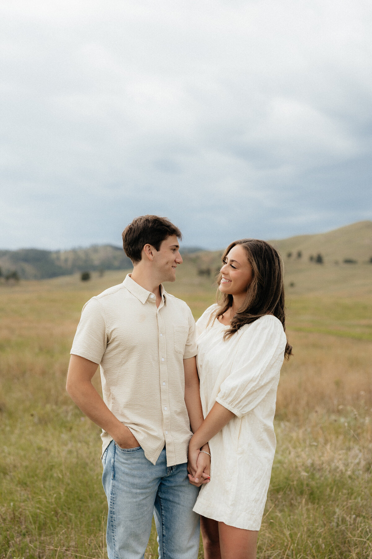 Christian and Olivia smiling at each other at their portrait session.
