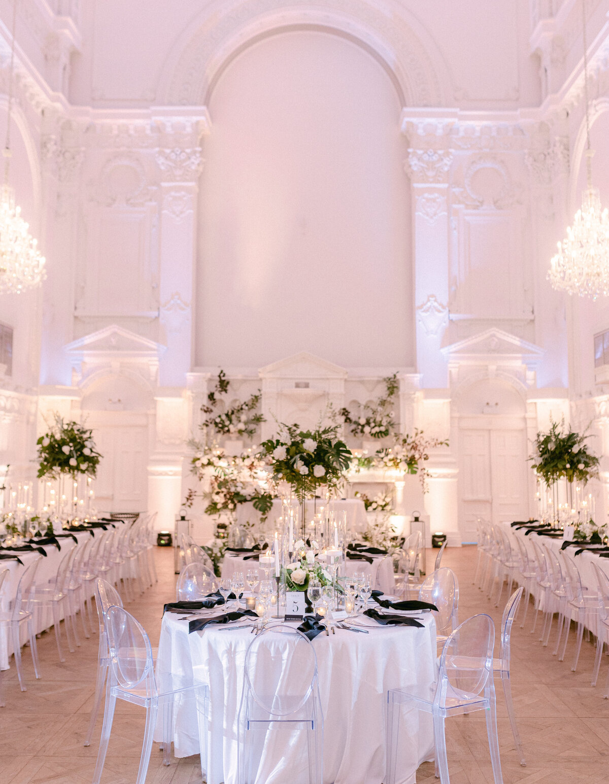 A wedding reception at Maison Principale shows exotic florals under high vaulted ceilings and elegant mouldings.