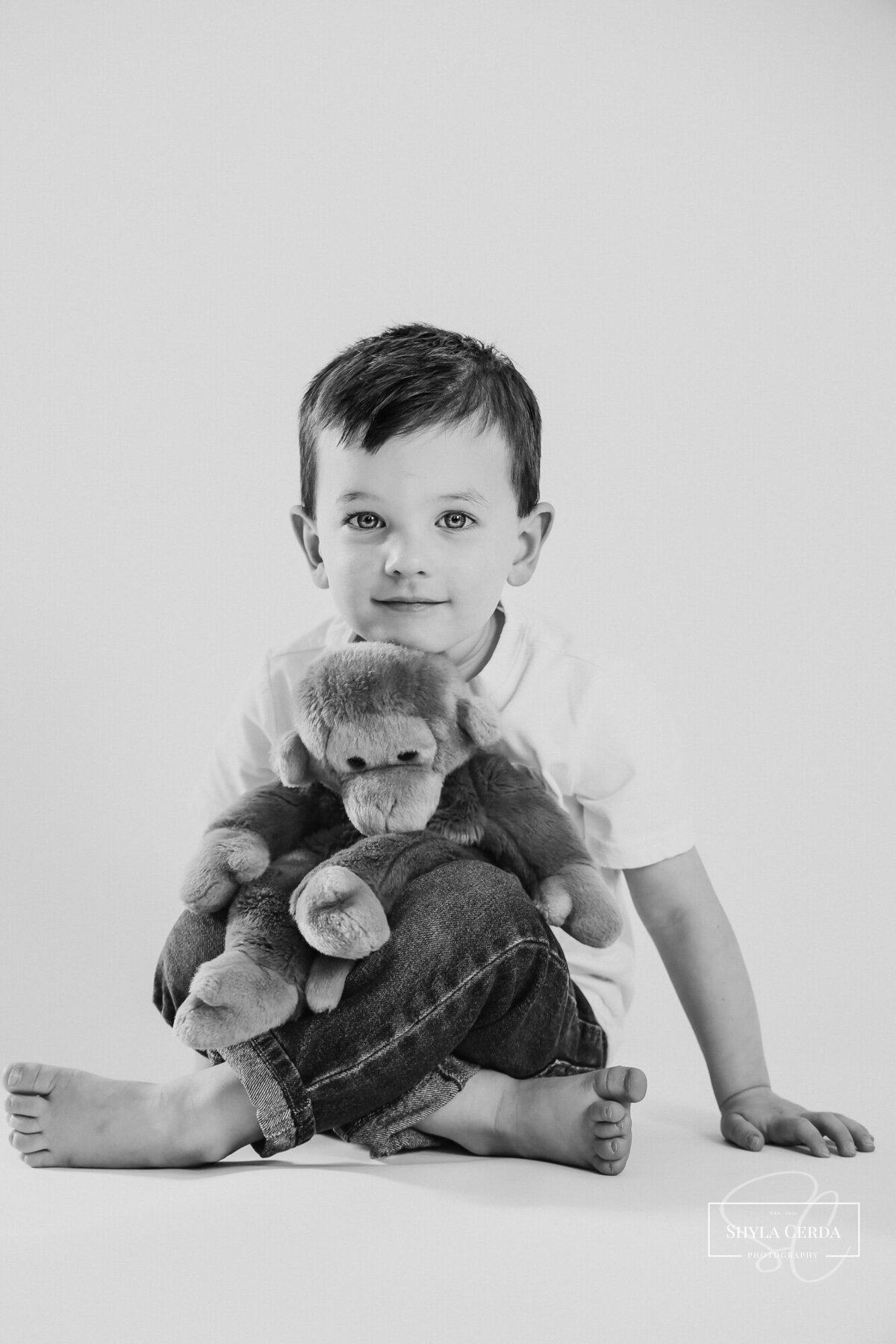 Little boy snuggling his favorite stuffed toy