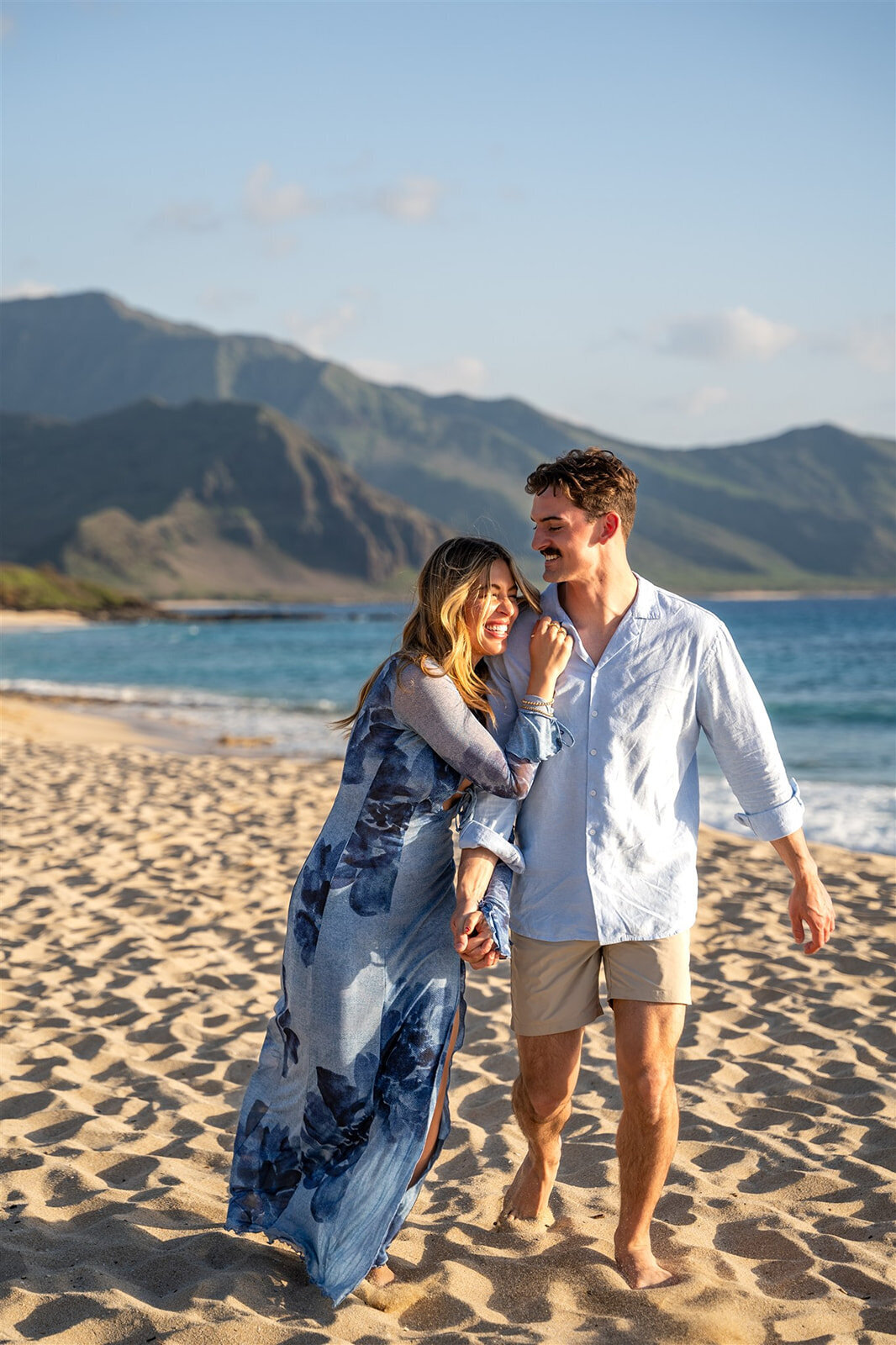 Couple playing on the beach for Hawaii engagement photography session