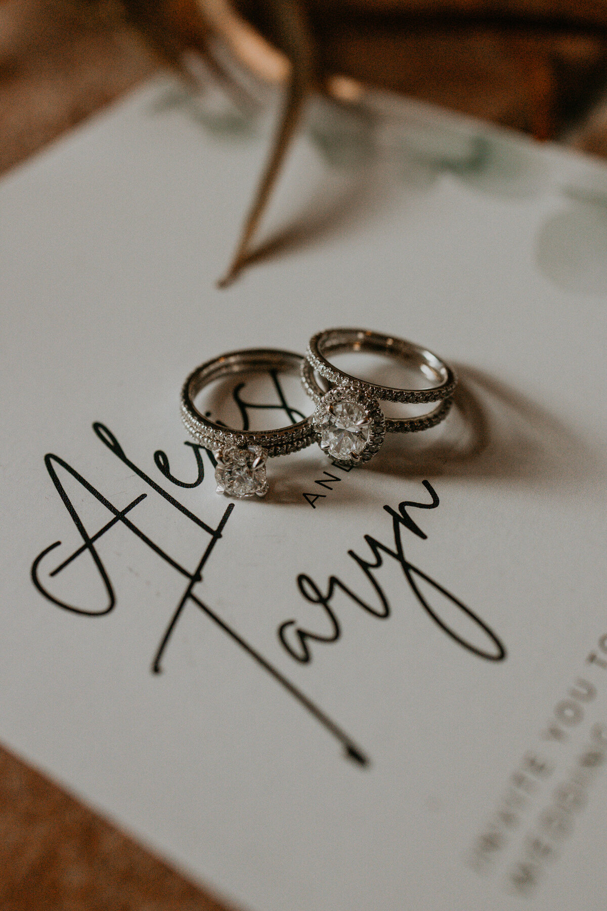 flatlay of a LGBTQ+ couples wedding details and jewelry