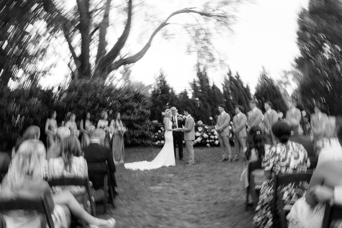 Bride and groom in black and white blur while at the alter saying their vows at the Cordell in Nashville, TN. 