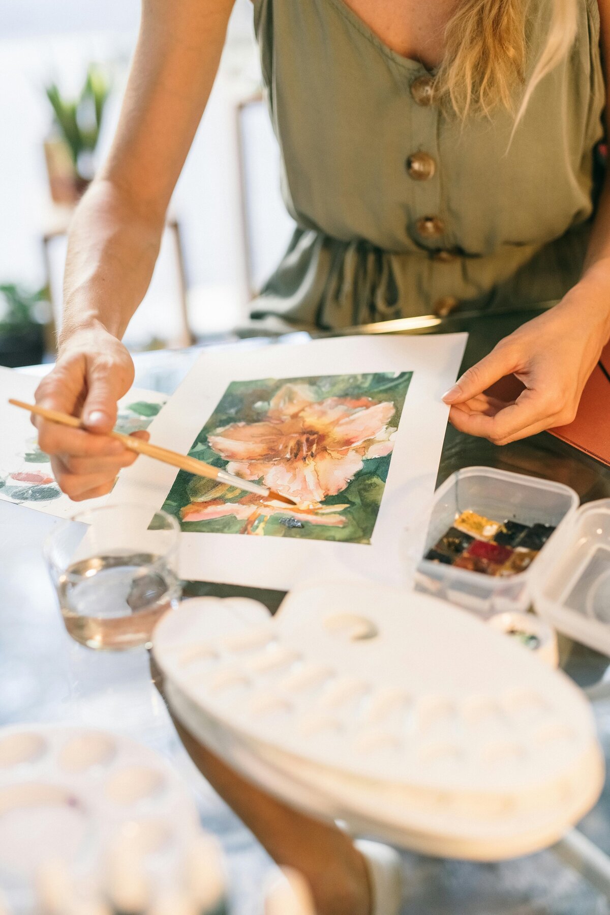woman painting a flower