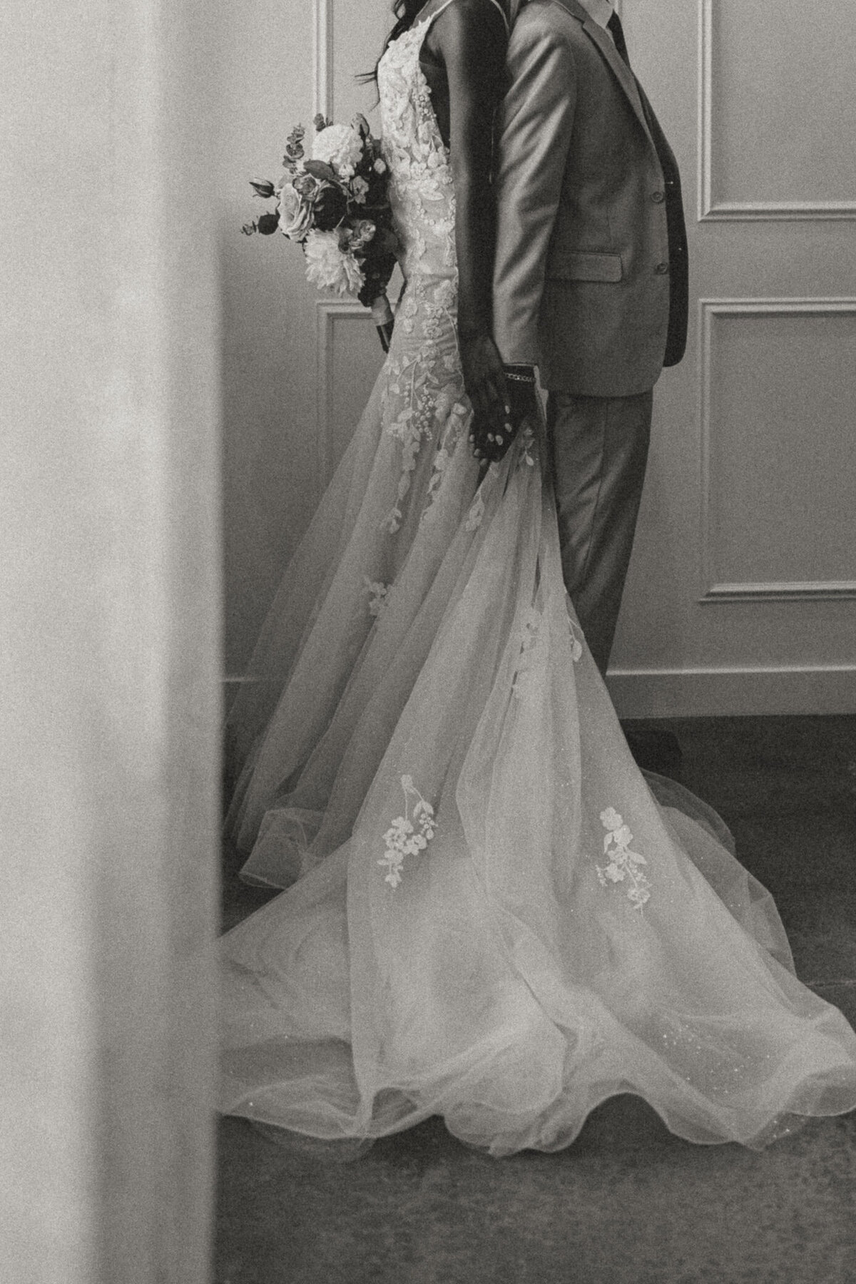 wedding-couple-back-to-back-holding-hands