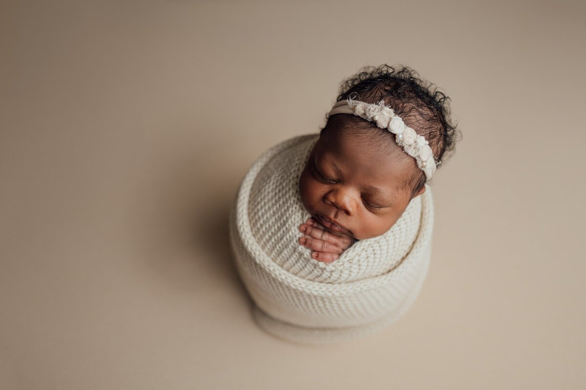 baby girl poses during newborn session in st. pete