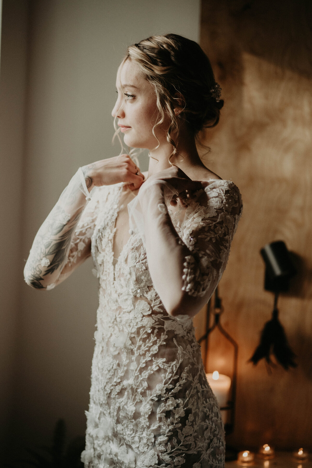 Bride putting her dress on while getting ready before elopement