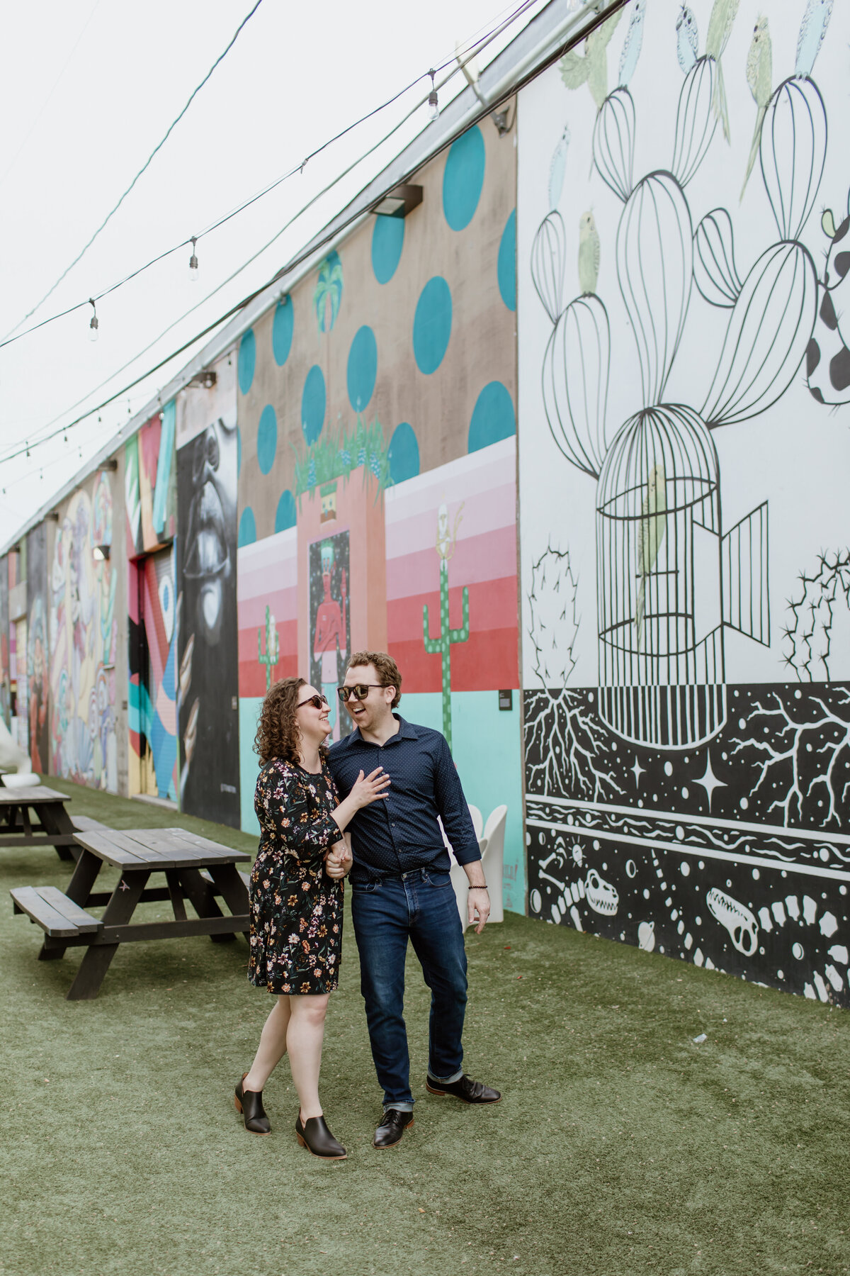 A playful and candid engagement session in Inspiration Alley. Captured by Fort Worth Wedding Photographer, Megan Christine Studio