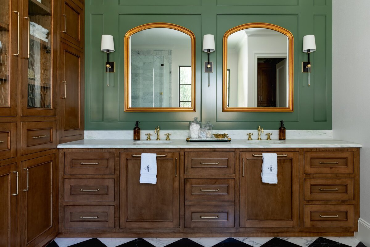 kyleen bushroe interiors coverdell bathroom with double sinks and gold framed mirrors