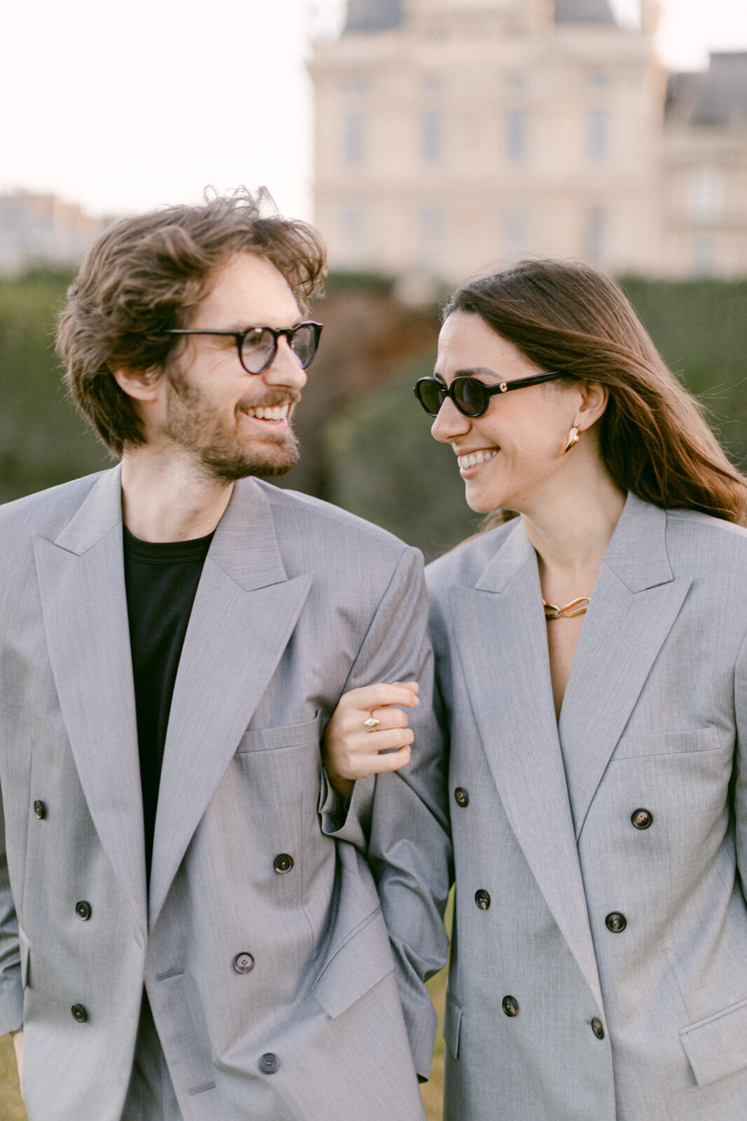 Engagement session at the Tuileries and Louvre in Paris, with a couple walking through the gardens under the morning light.