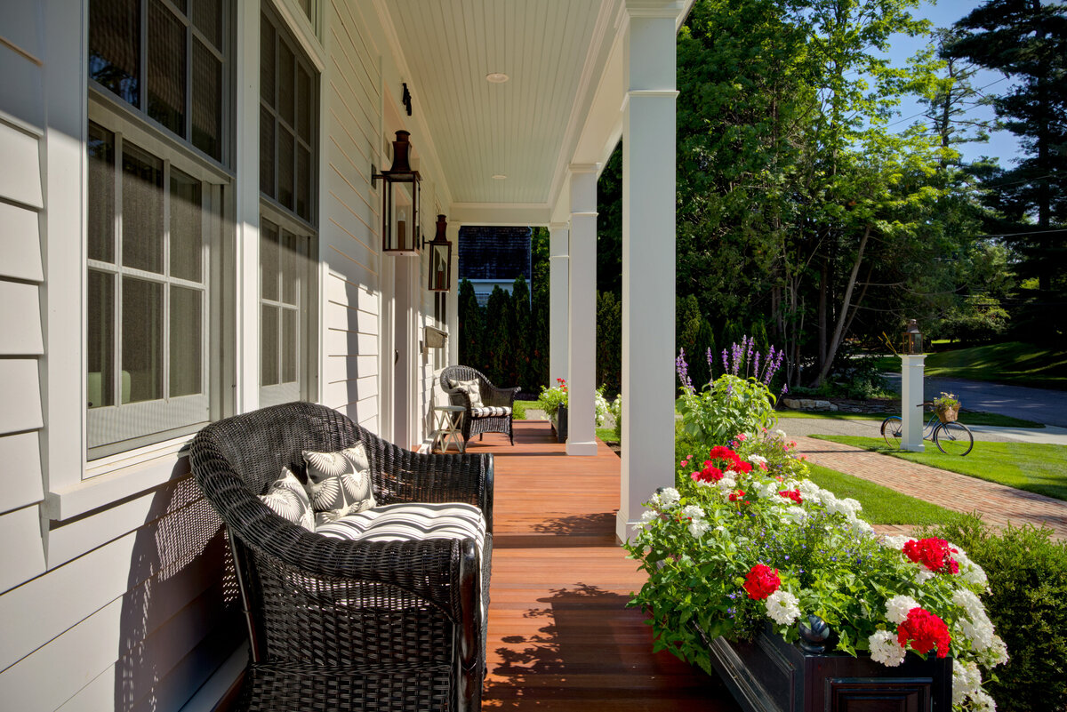 outside view of white house with porch and sitting area