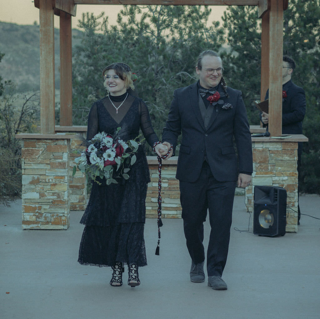 A couple walking back up the aisle after their wedding.