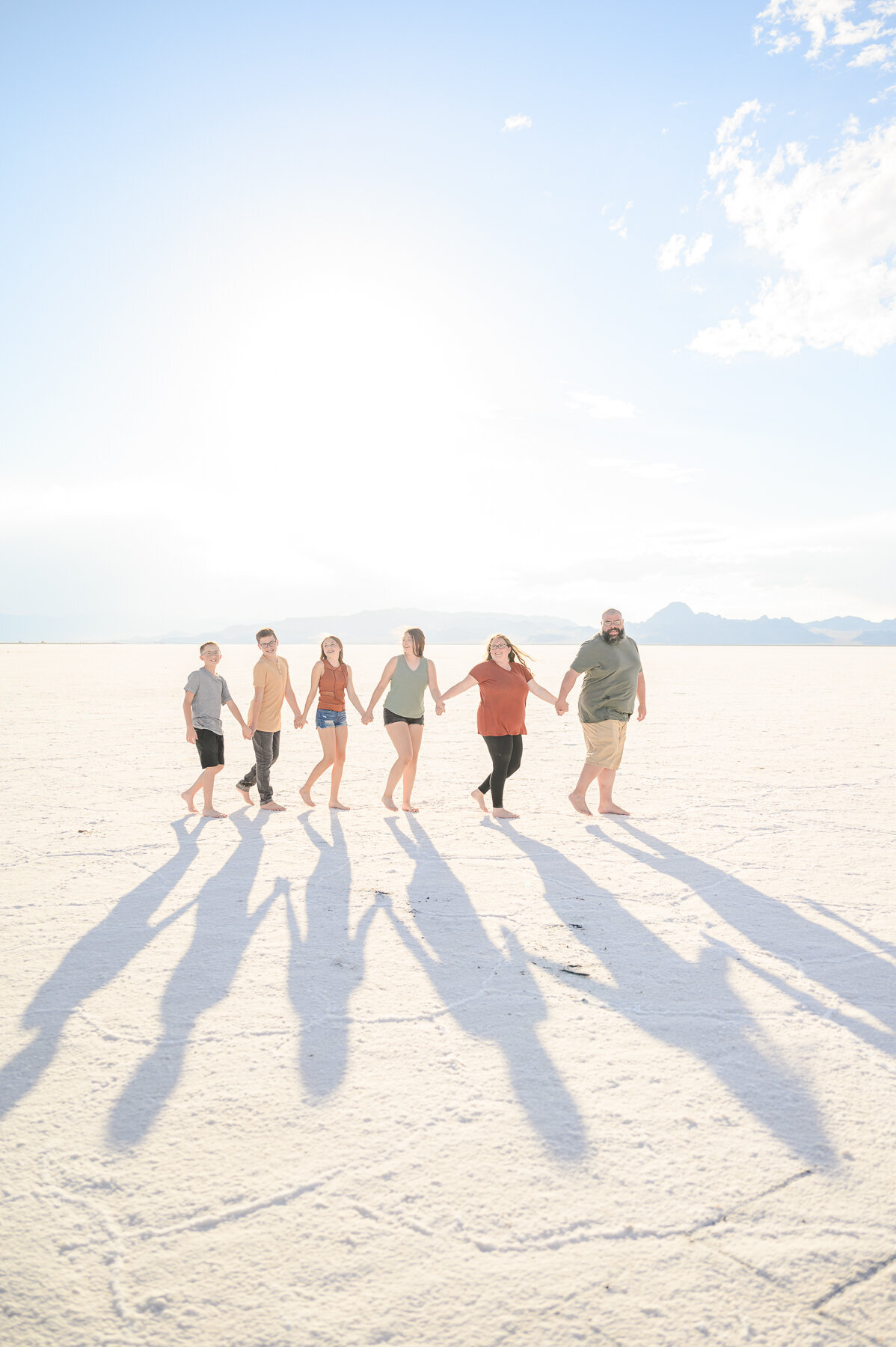 family walking at sunset at salt flats utah for family pictures