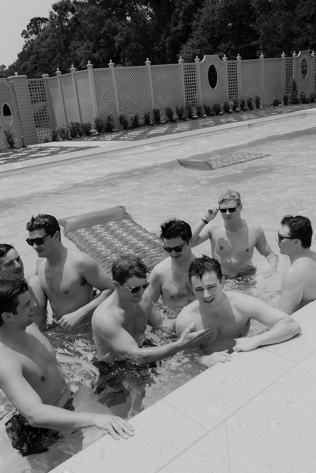 Groom and groomsmen enjoy some pool time before the wedding