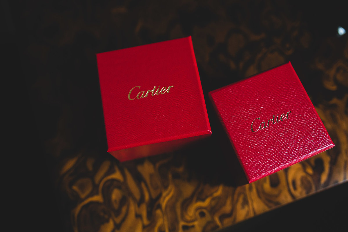 A photograph of Cartier wedding rings on the table