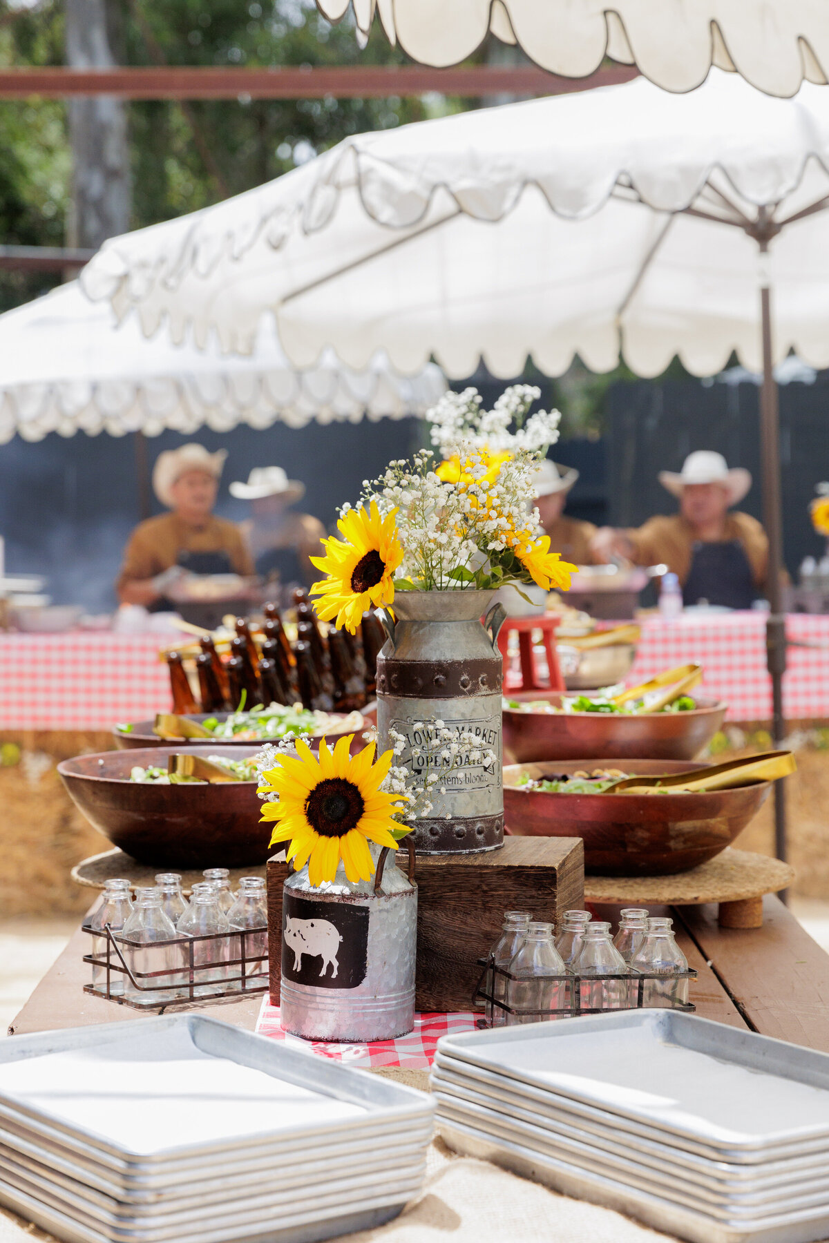 Old milk jugs and beer sitting on a table