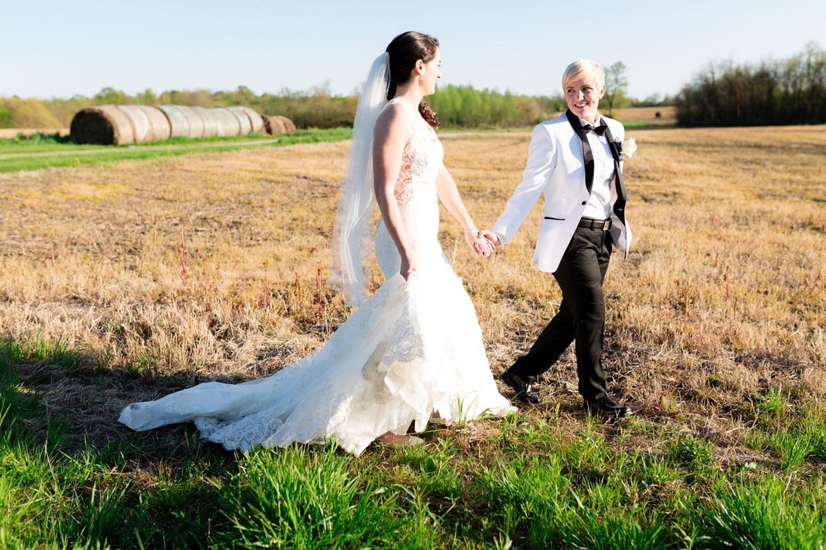 Wedding couple walking through a field at wedding in Tennessee