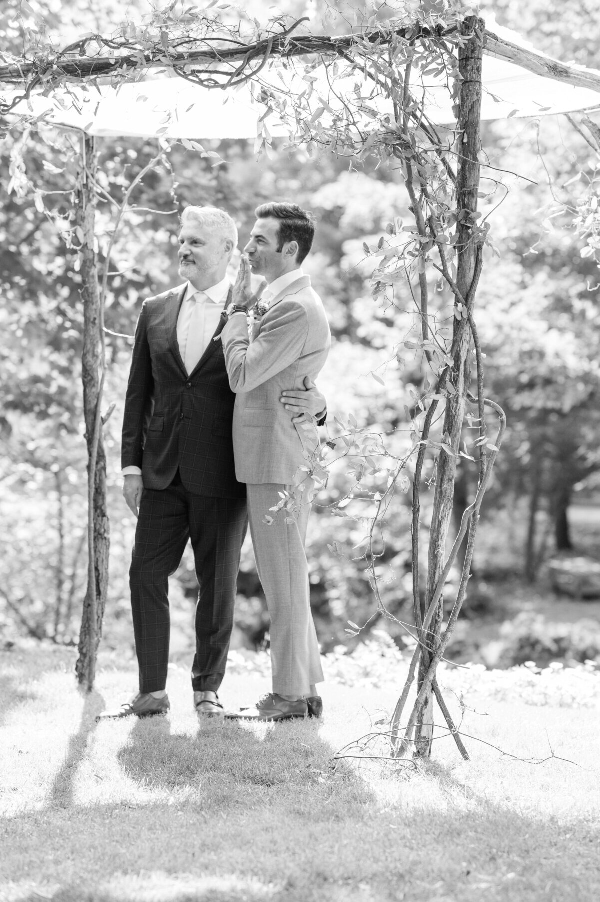 Grooms hold each other prior to the ceremony 