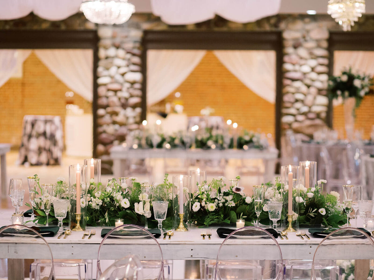 Custom wedding dining tables with emerald green garlands