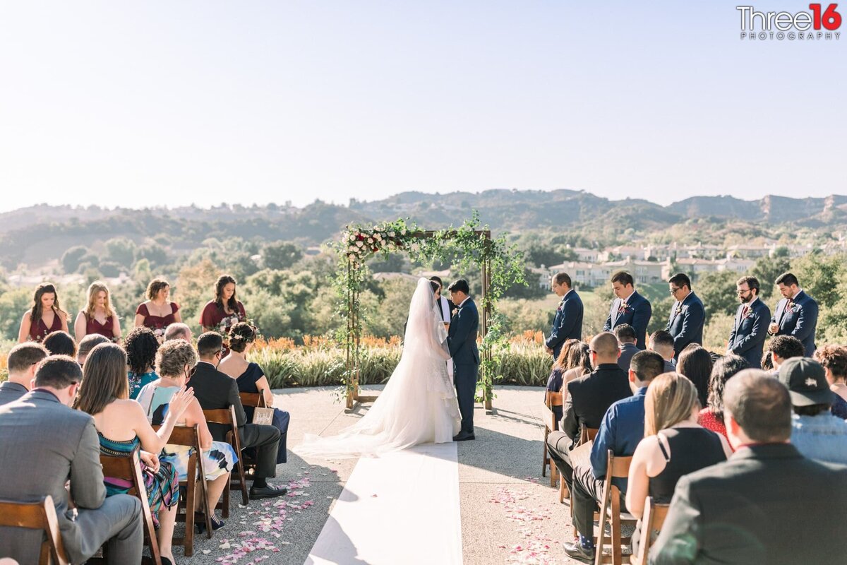 Bride and Groom face each other during their wedding ceremony