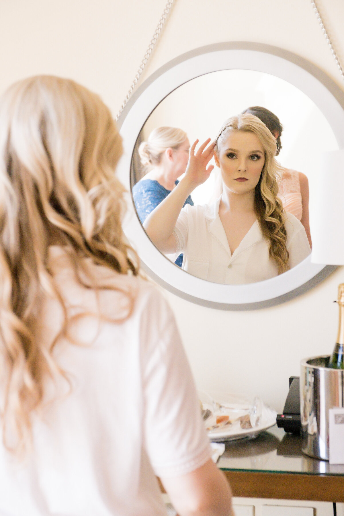 bride looking in the mirror as she is getting ready for her event at the fairmont hotel pittsburgh
