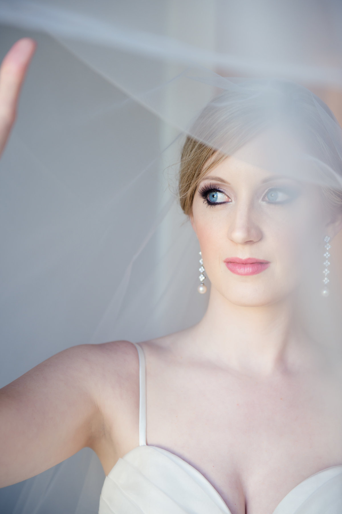 Bride holding veil by Brittany Barclay Photography
