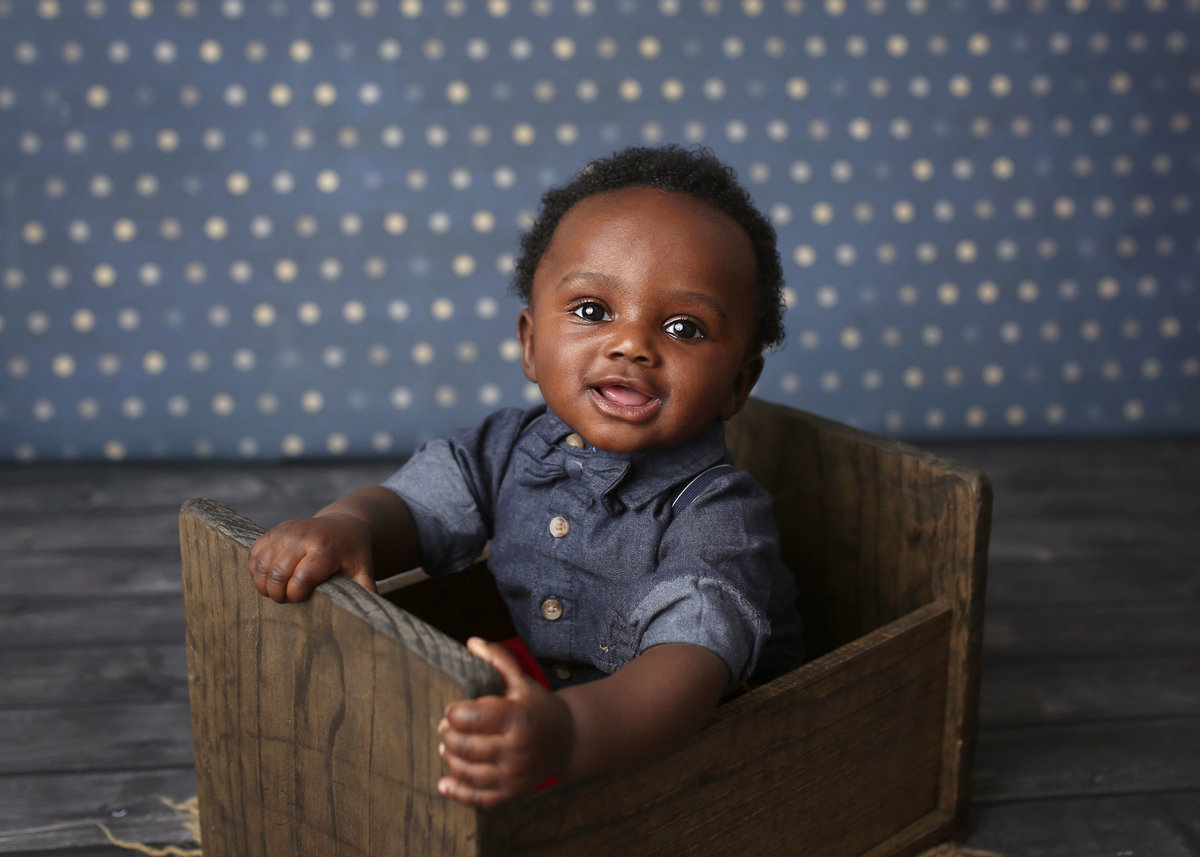 baby boy posed in wooden prop
