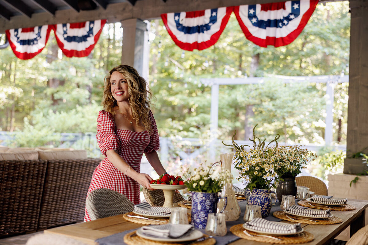 a woman creating a fourth of July table spread