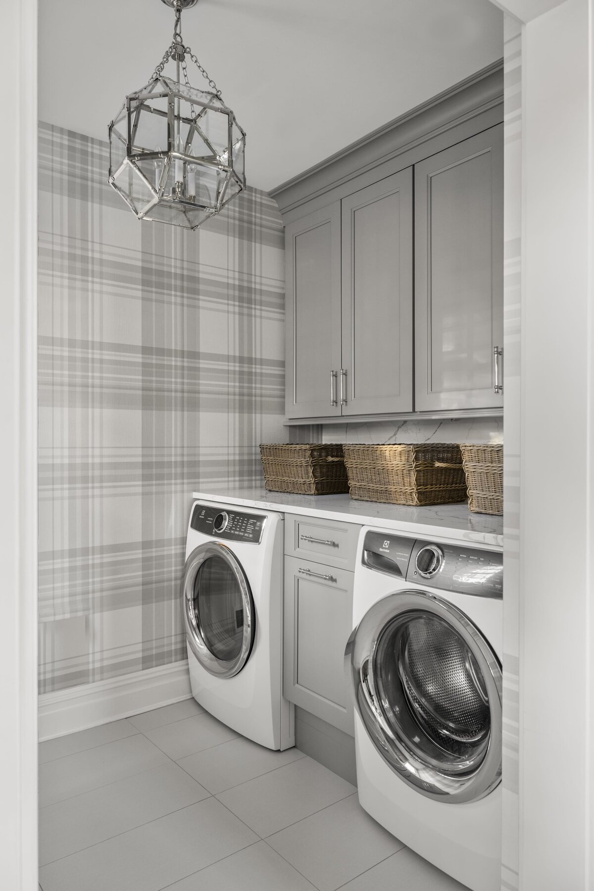 candra lynn interiors ocean port project laundry room with neutral cabinets and striped wallpaper