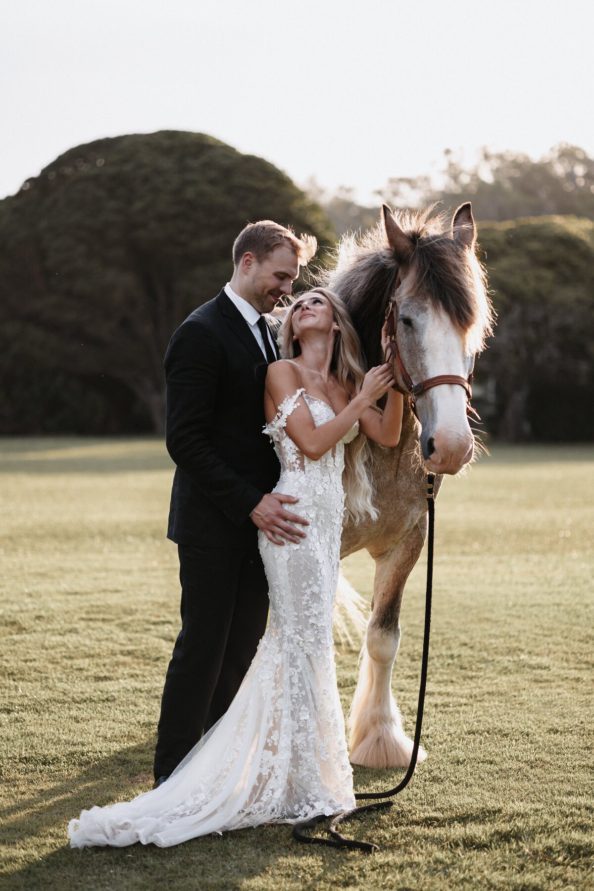 Elopement Photography, bride and groom staring into each others eyes posing with a horse