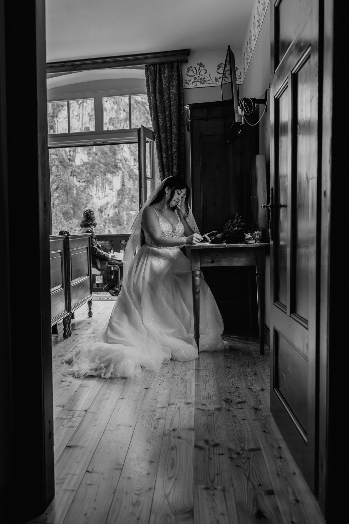 Bride writing vows inside cozy cabin room