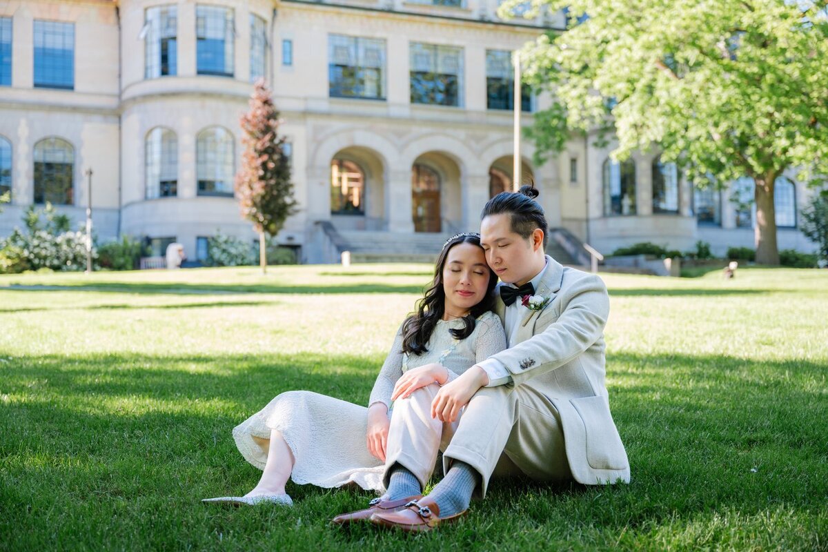 university of washington bride and groom sitting on grass