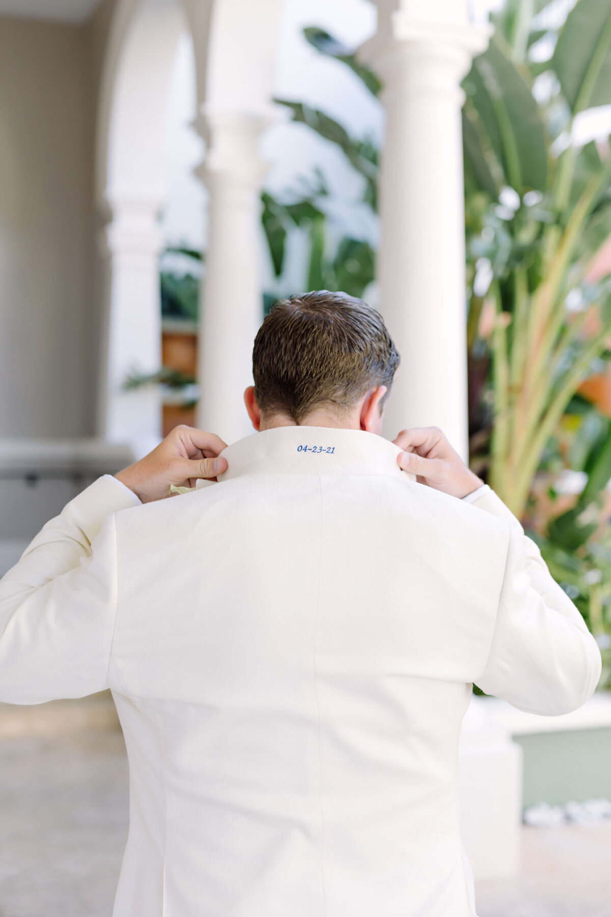 groom in white tux for destination wedding