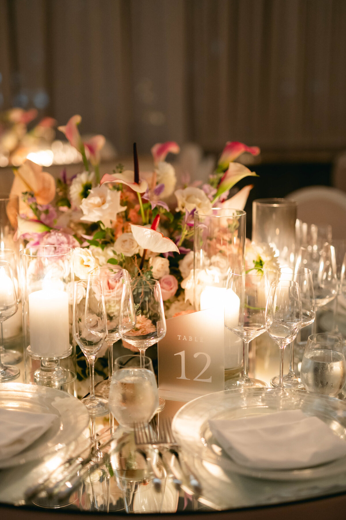 An intimate table setting at a Theatre St James wedding reception featuring a bright floral centrepiece.