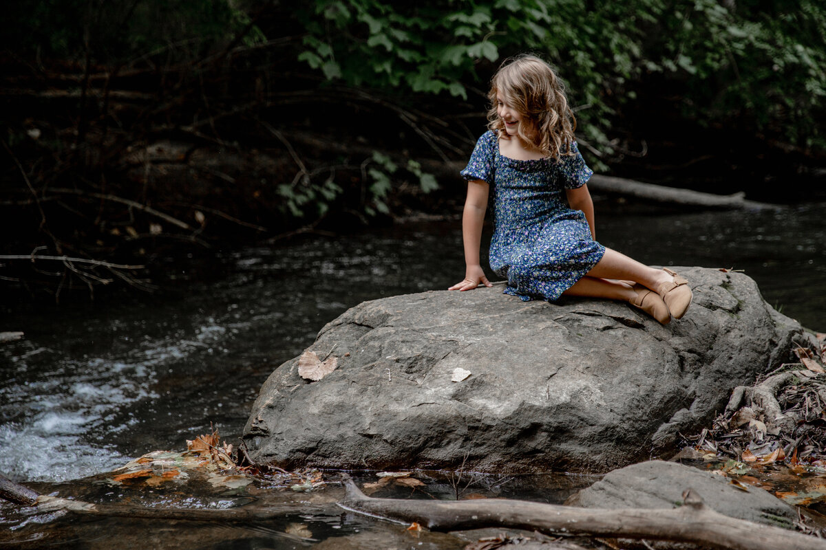 girl-rock-sitting-river