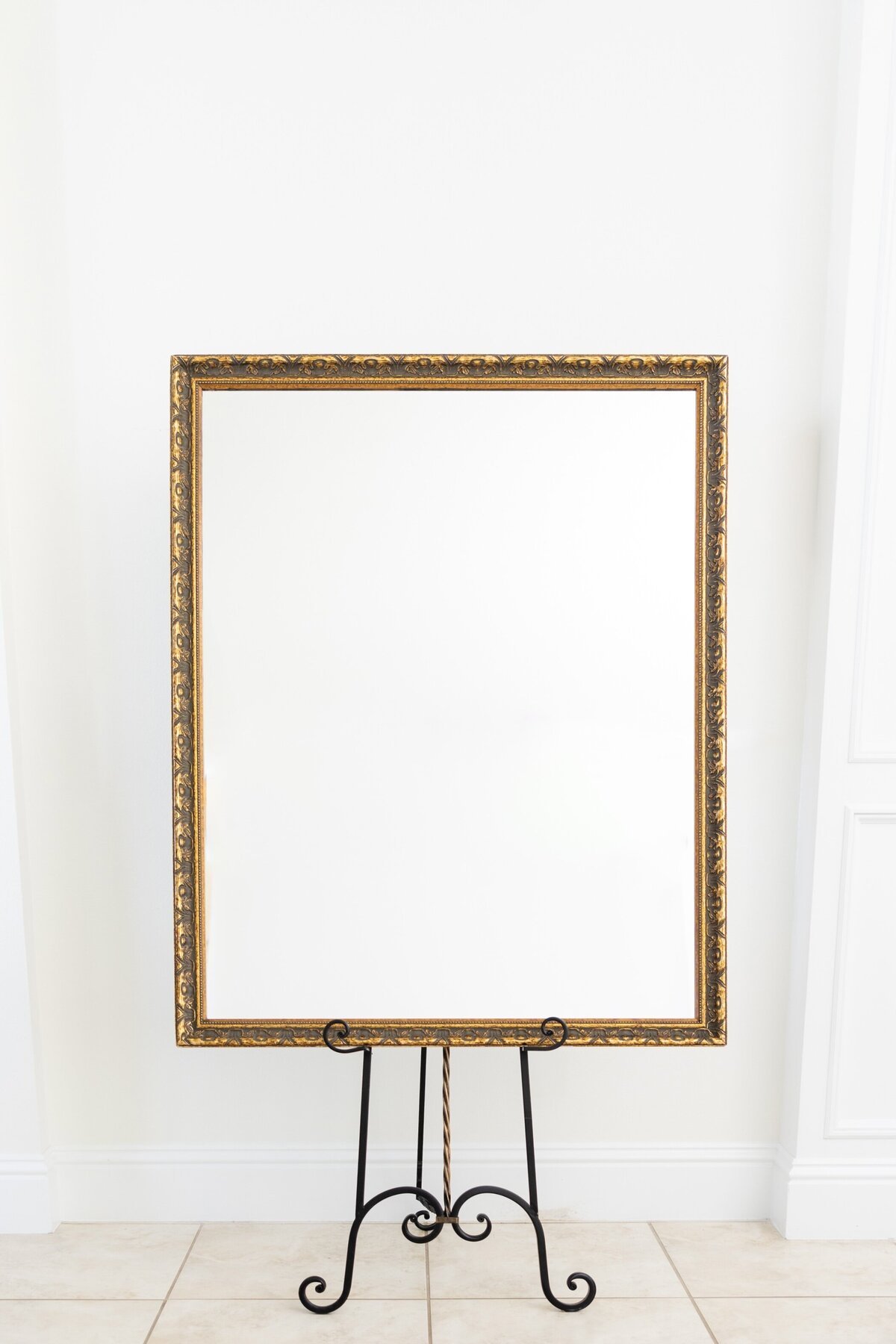 Large gold mirror with ornate border 