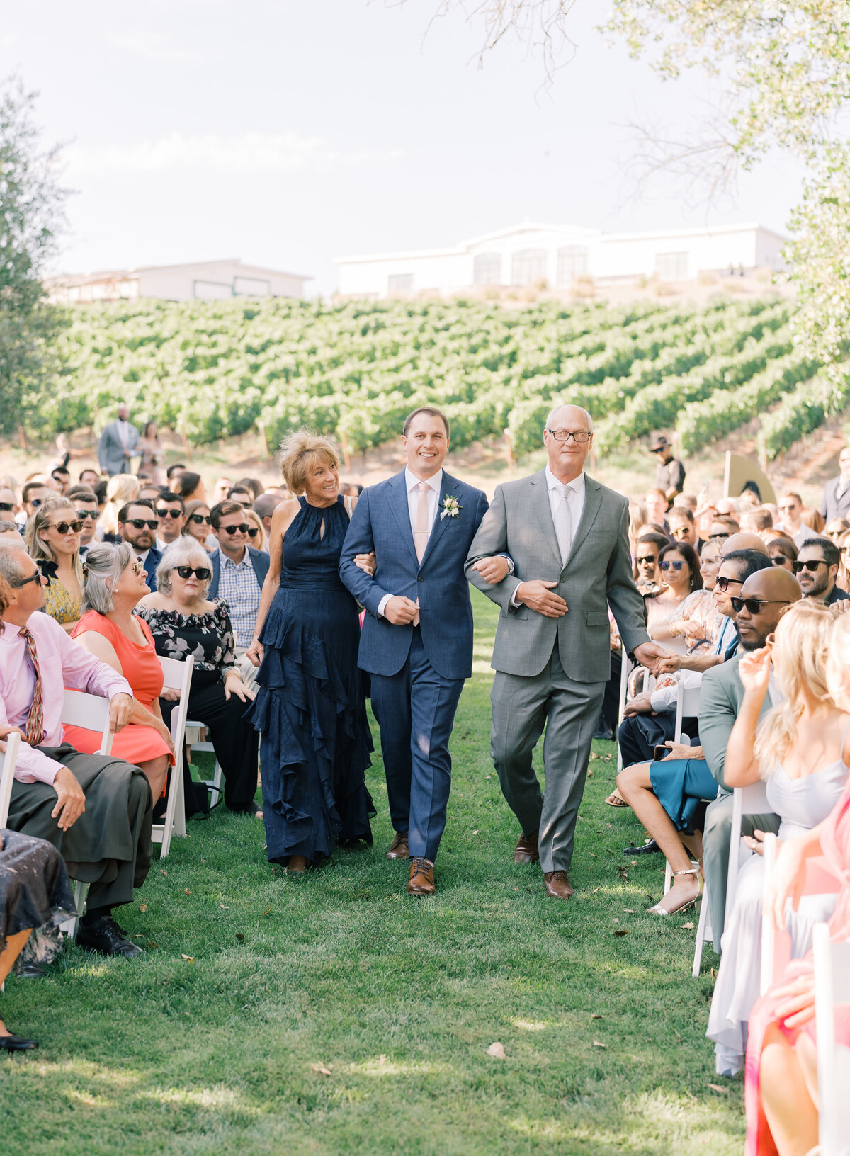 groom walking with parents down the aisle at Greengate Ranch wedding