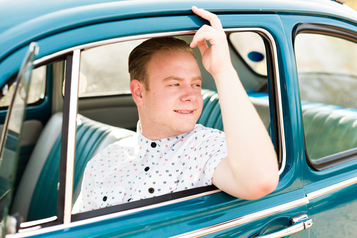 high school senior boy posing for Scottsdale senior photography session in VW bug