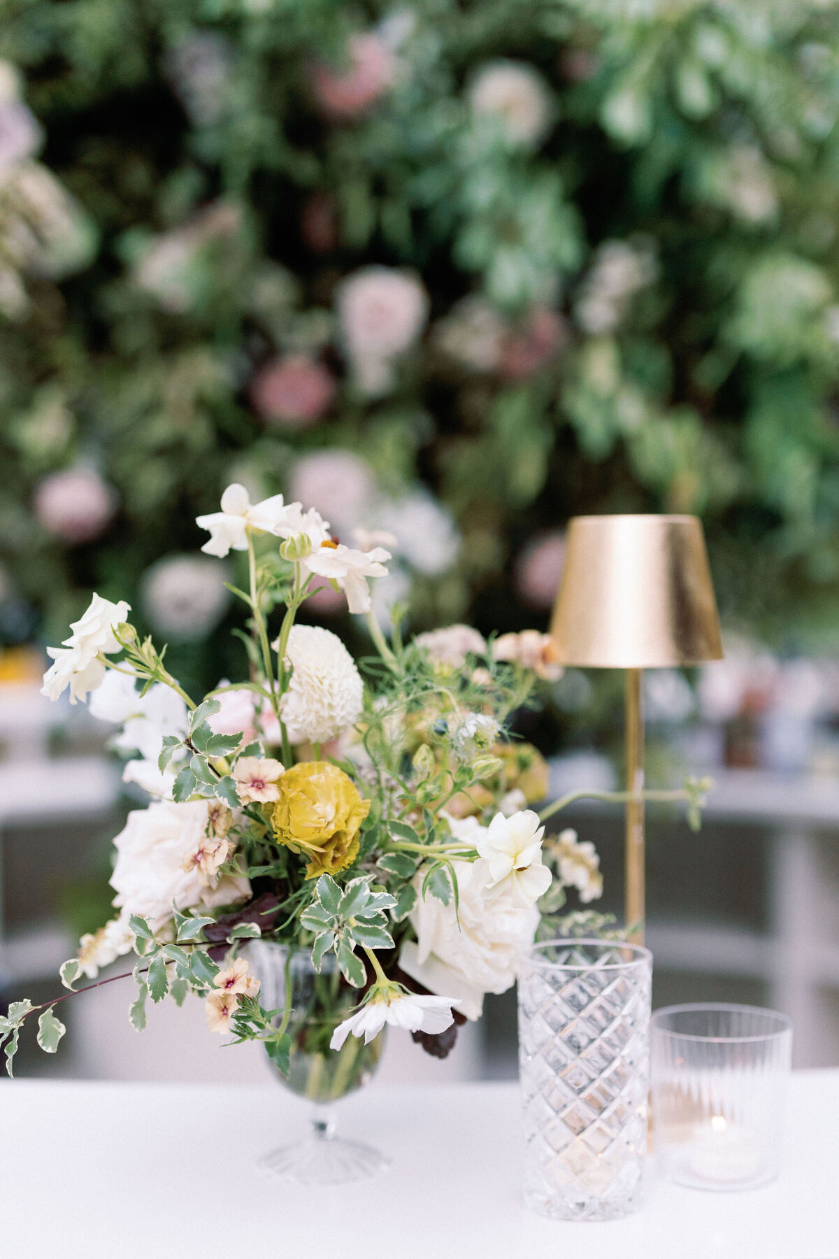 Wedding reception florals in glass vases with elegant design in hues of white, cream, blush, and natural greens. Garden inspired floral design for fall wedding in Tennessee. Lush fall florals featuring roses, dahlias, zinnias, smokebush, and natural greenery. Destination floral design for whimsical and romantic weddings. Design by Rosemary & Finch Floral Design in Nashville, TN.