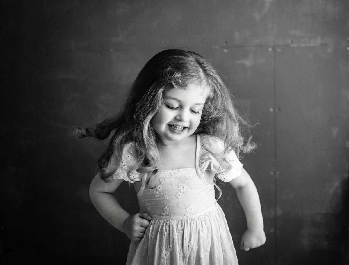 Sweet black and white photograph of a happy young girl with flowing hair during a portrait session in Mullingar