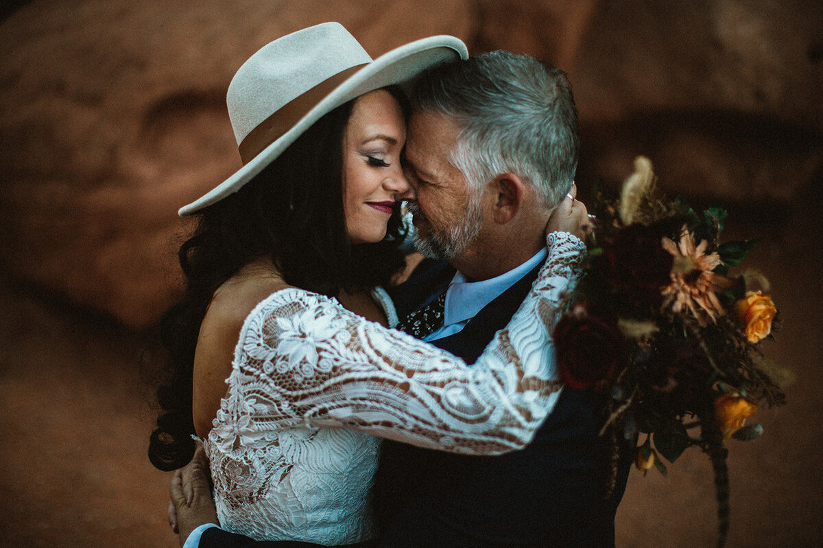 bride hugs groom in garden of the gods Co