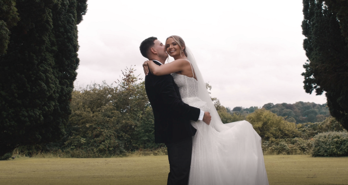The Bride and Groom embrace at Barton Hall in Northamptonshire on their wedding day. Captured on film by Northamptonshire wedding videographer HC Visuals.