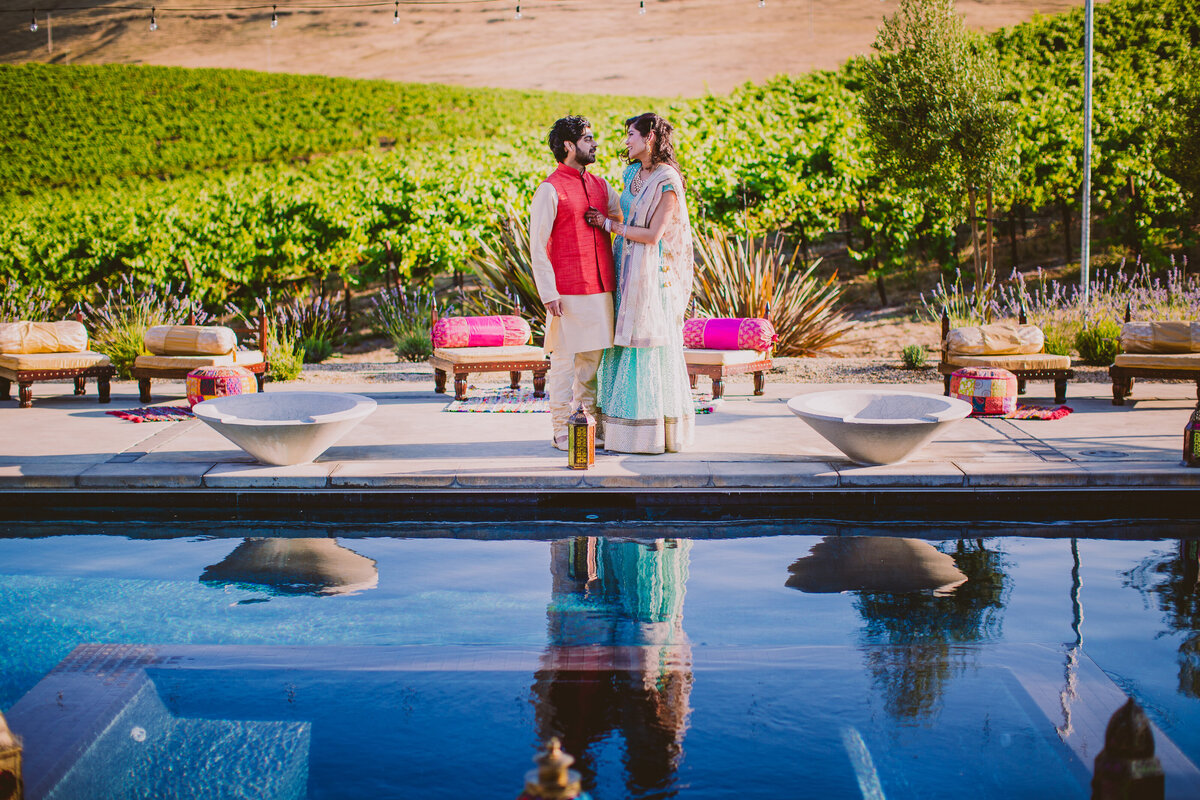 indian bride and groom share a moment poolside at the glasshouse vineyard in sonoma county california