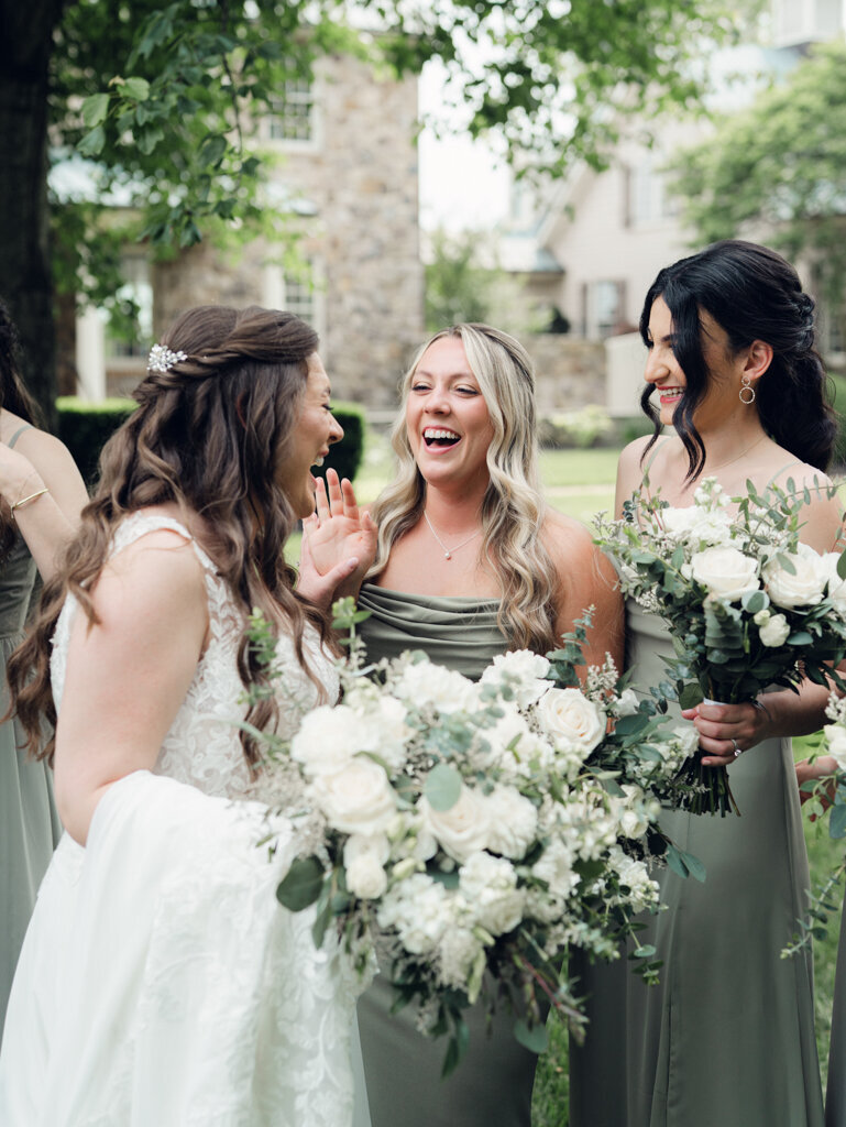 bride laughing with her bridesmaids taken by washington dc wedding photographer Nicole Simensky