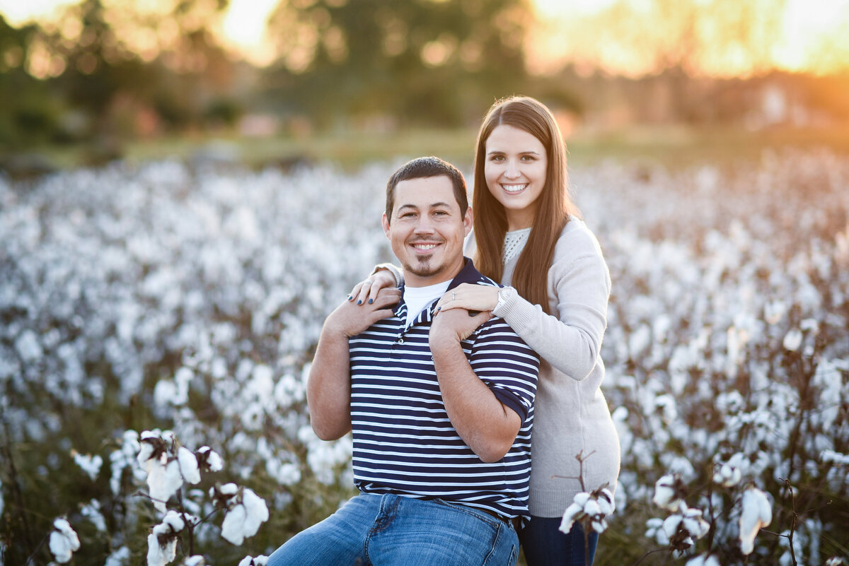Beautiful Mississippi Engagement Photography: couple poses in a Mississippi cotton field at sunset