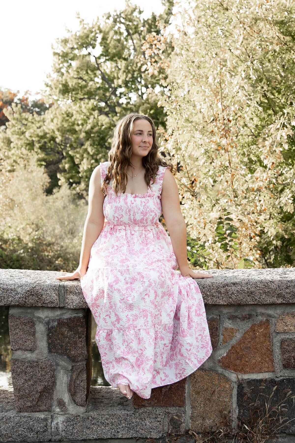 senior-girl-in-pink-dress-swinging-legs