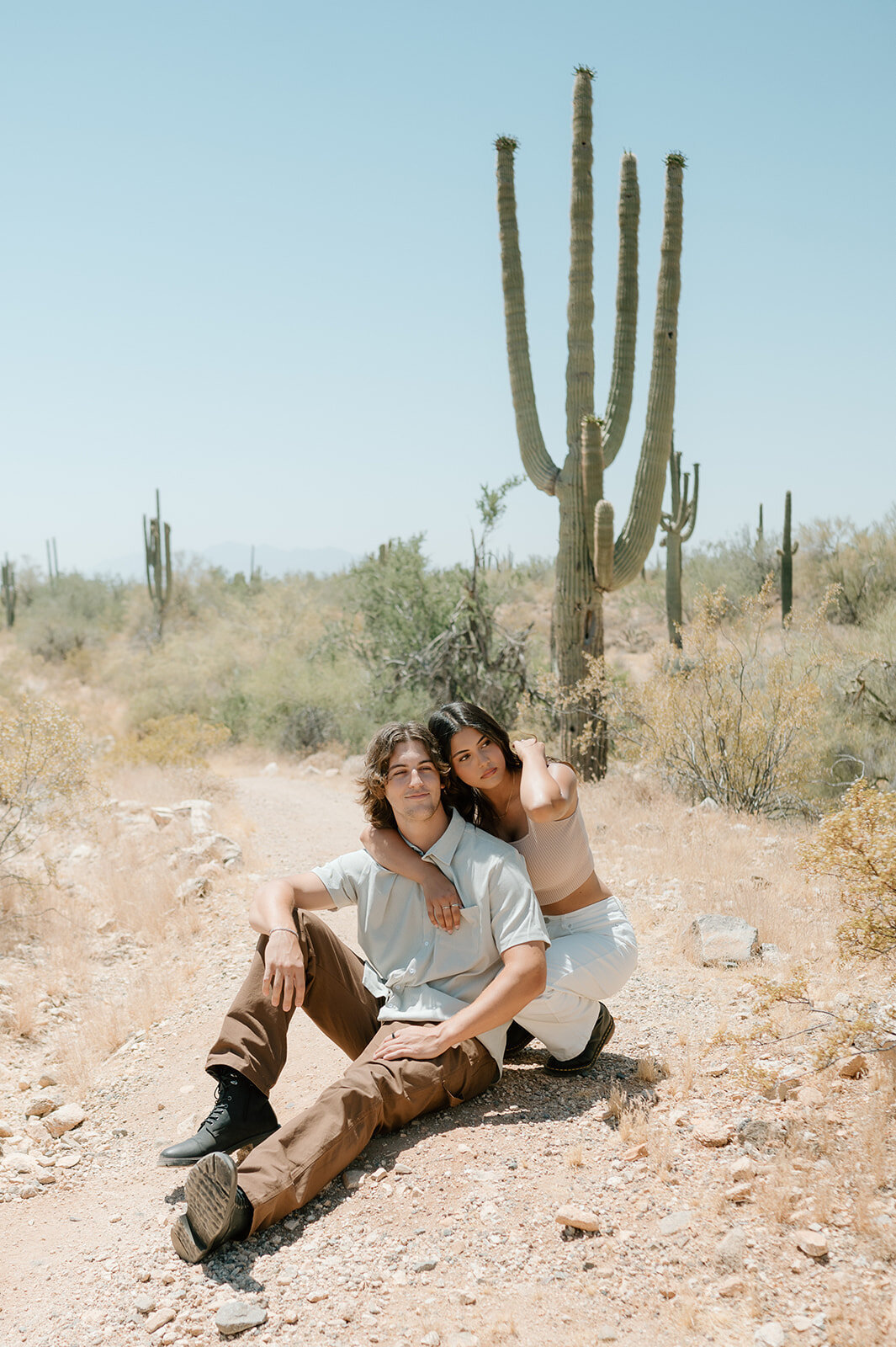couple sitting in desert during couples photos