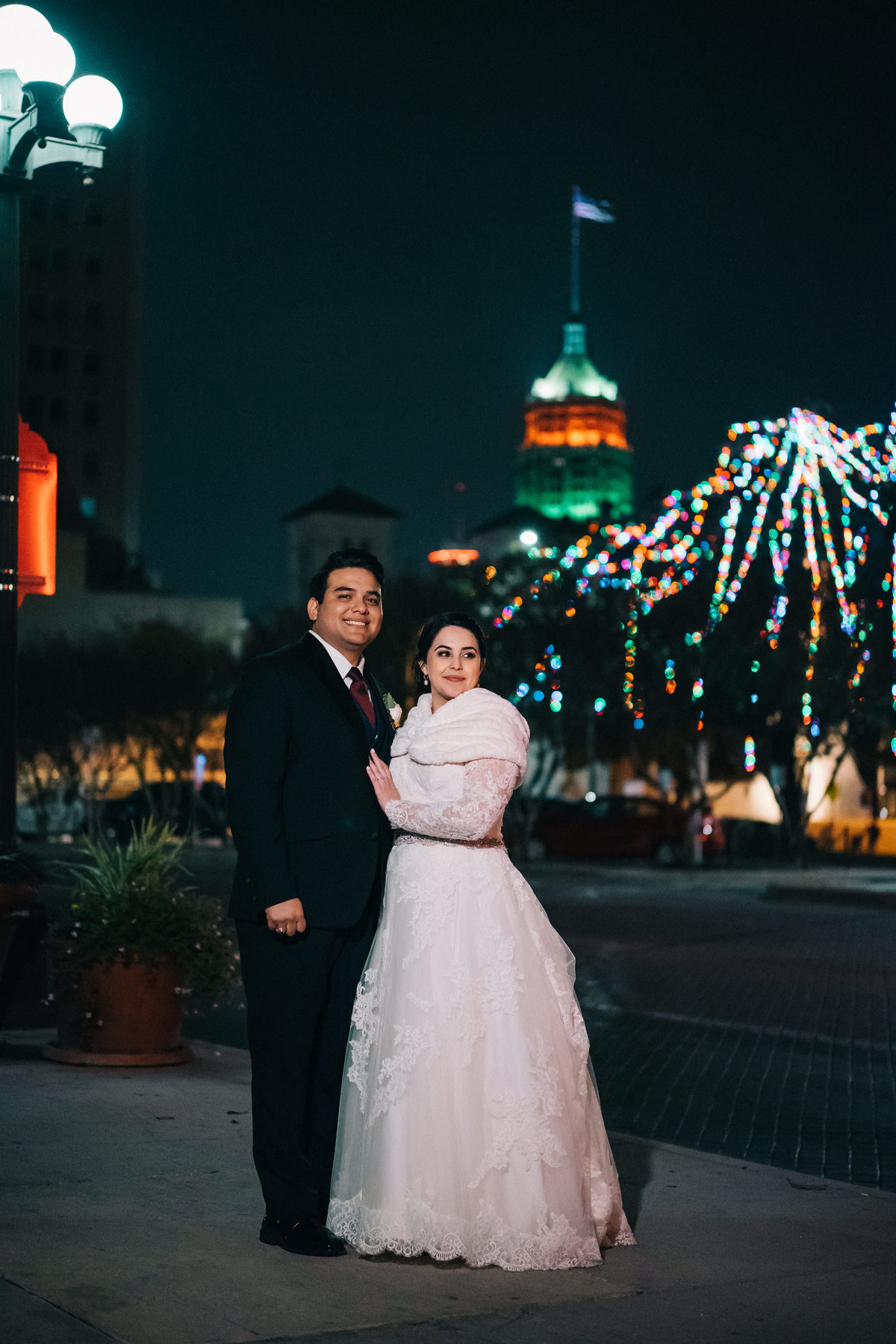 bride and groom posing in downtown San Antonio posing for a picture by Expose The Heart Wedding Photography