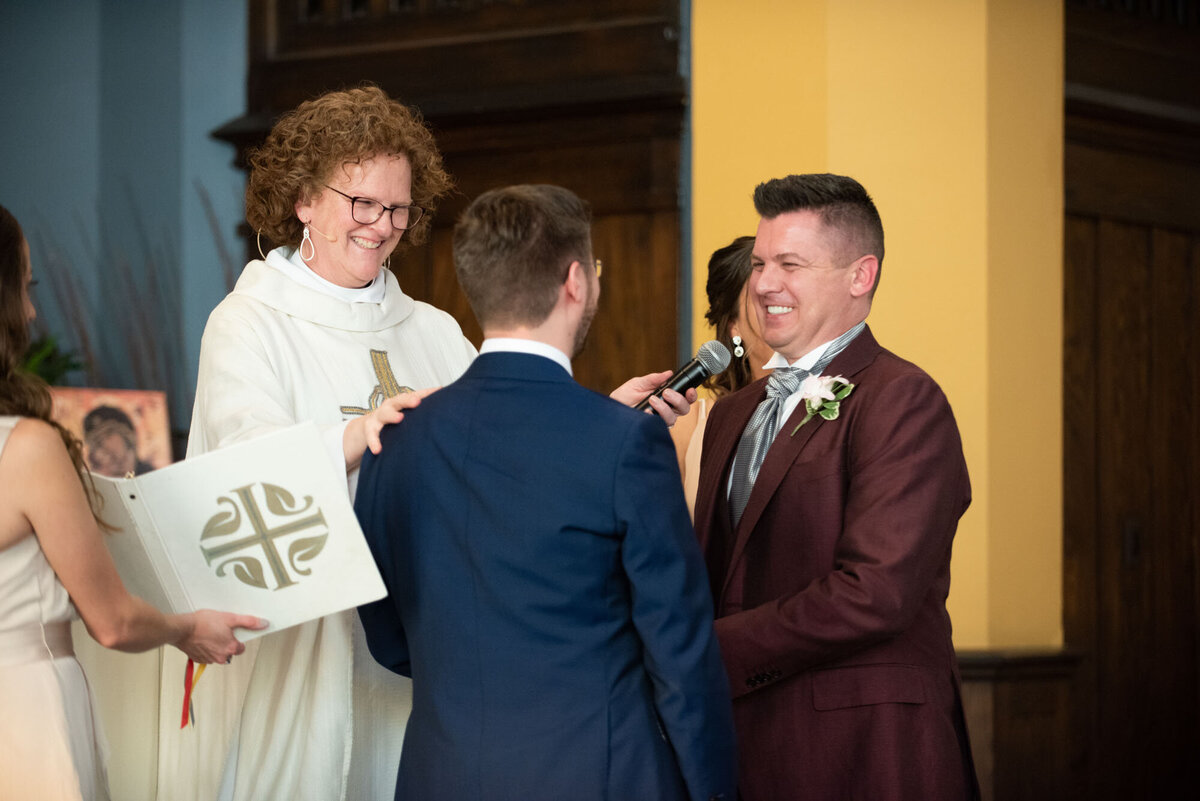 A man in a suit is being interviewed by a woman in a white robe